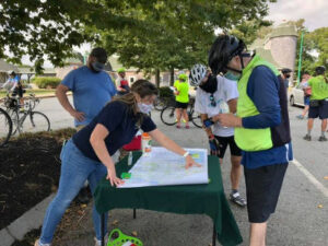 Volunteer helping an event participant with route map