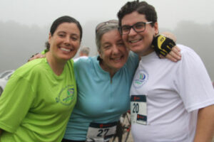 Three smiling people volunteering at a South Coast Bikeway event