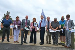 Group of Massachusetts Officials cutting the ribbon on the Shining Tides section of the Mattapoisett Rail Trail.